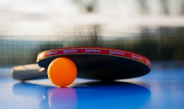 Tischtennisplatte: Tischtennisball mit Tischtennisschläger.